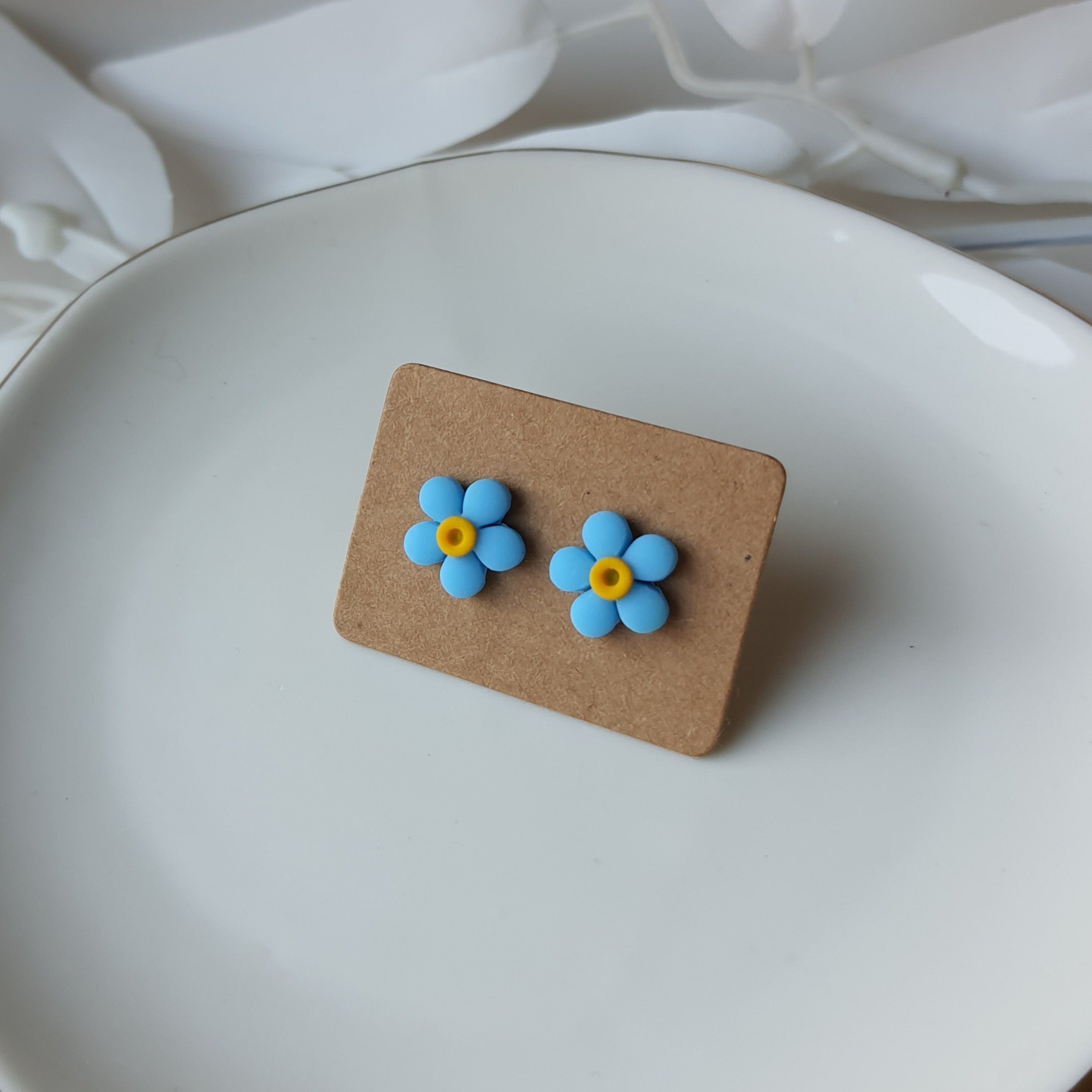 Neon blue flower stud earrings