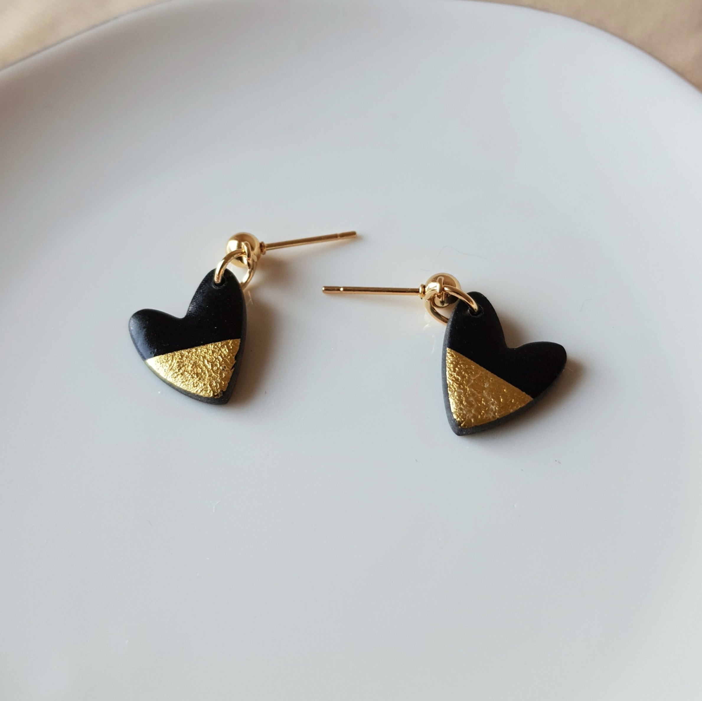 Black hearts with golden flakes dangle earrings