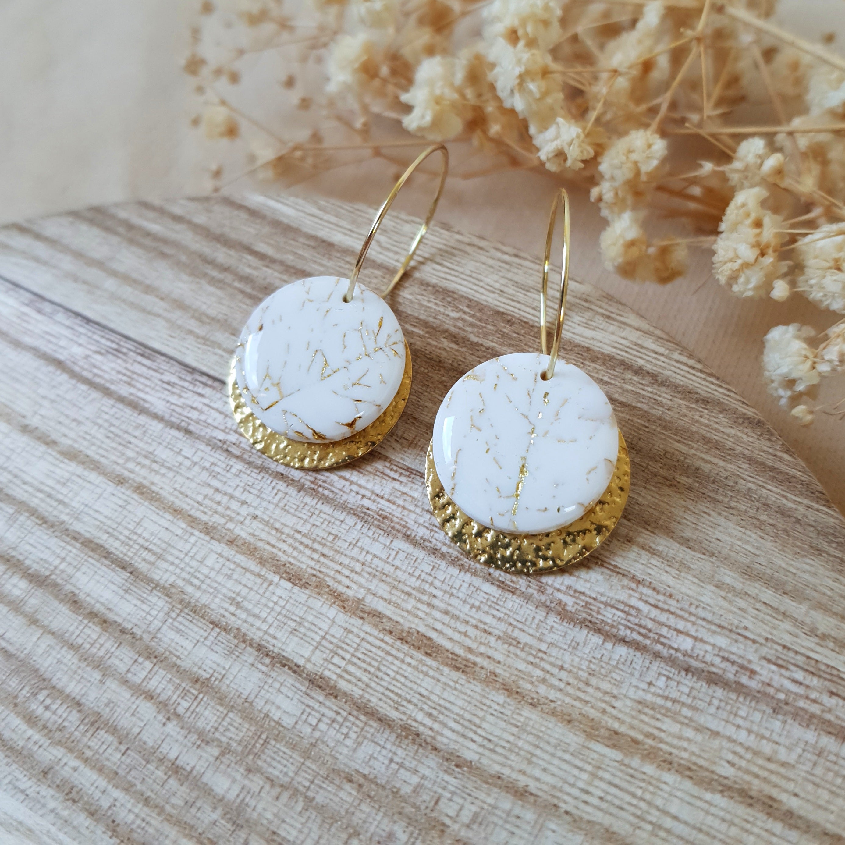 White stone on gold hoop earrings